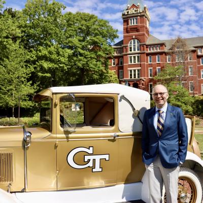 Image of Peter Graening with the Ramblin' Reck in front of Tech Tower