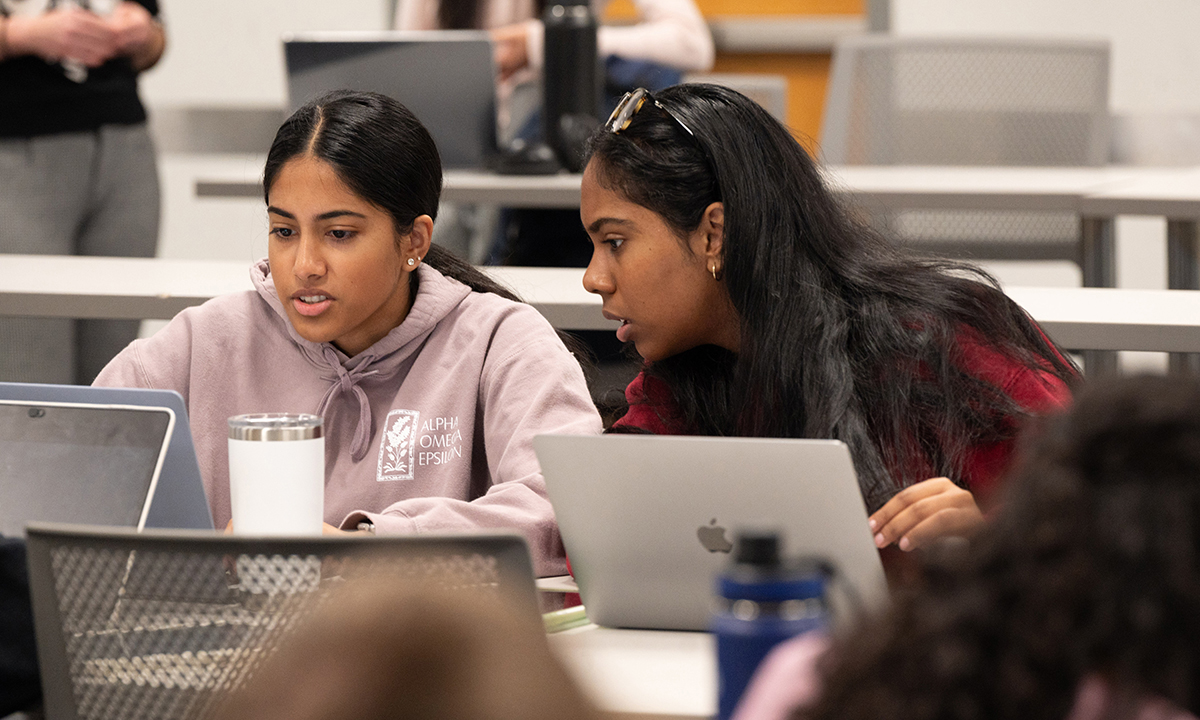 Two students discussing their classwork in a Georgia Tech classroom