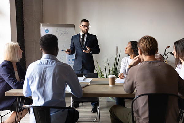 A consultant speaks with his coworkers